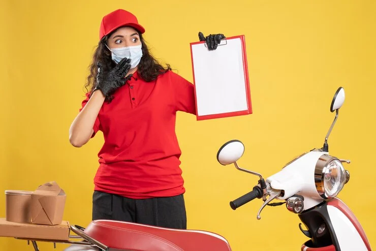 front-view-female-courier-red-uniform-holding-file-note-yellow-floor-delivery-covid-service-uniform-worker-pandemic-job_179666-39126