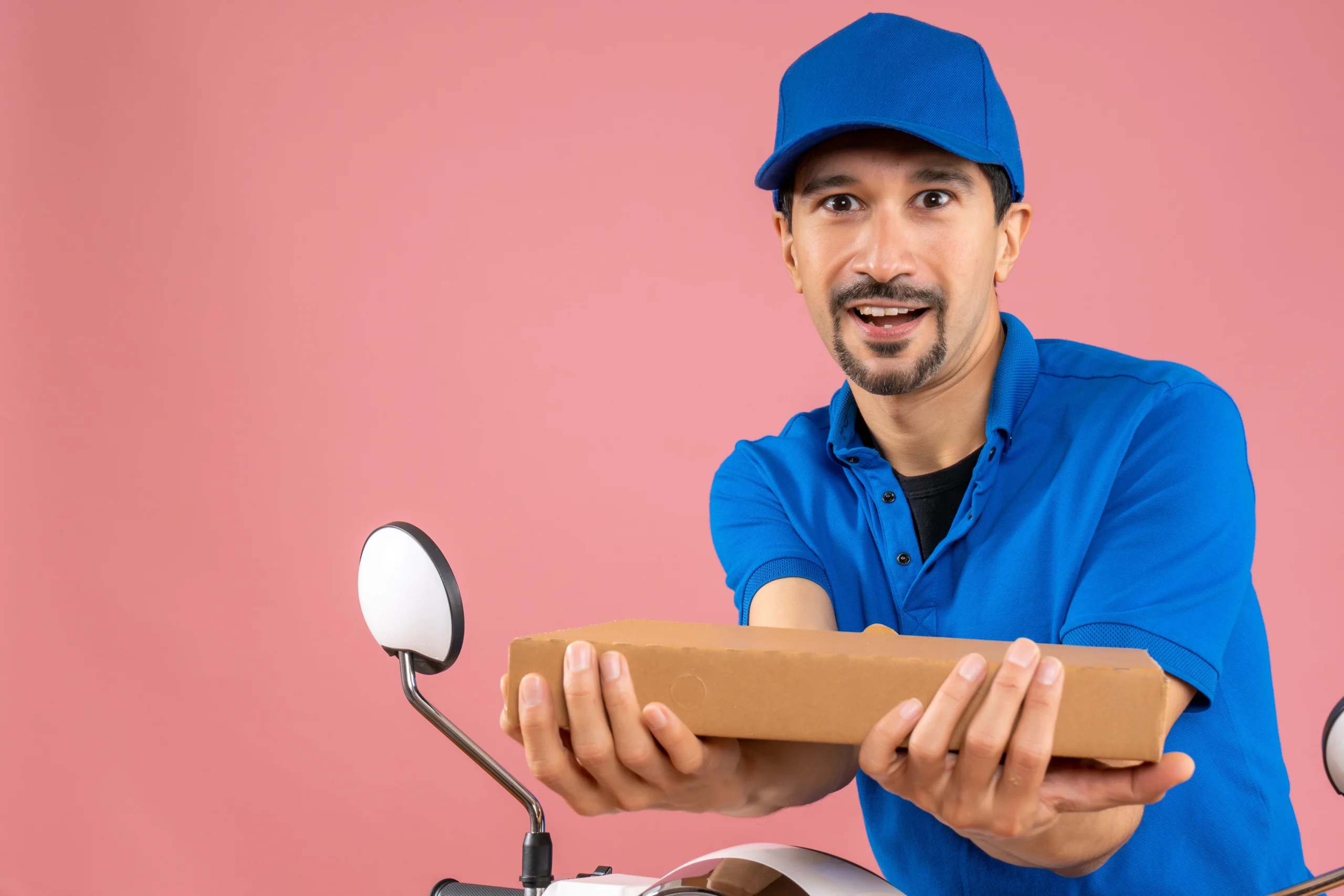 half-body-shot-confident-male-delivery-person-wearing-hat-sitting-scooter-holding-order
